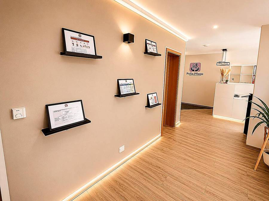 Bright hallway with indirect lighting and certificates on the wall in the PoSa head office